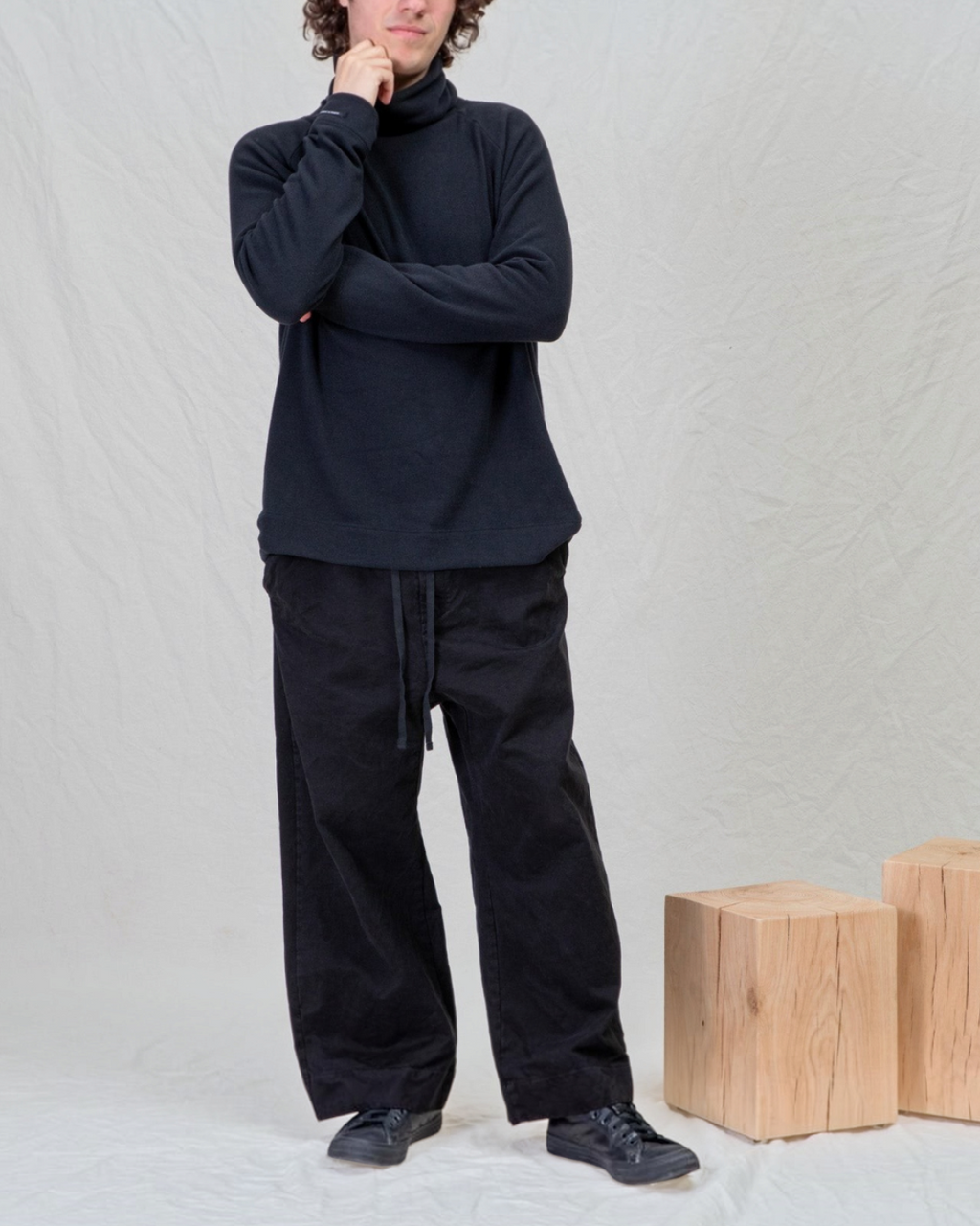 Homme portant un pantalon large noir en coton épais Album Di Famiglia de Merci Paris, style décontracté et minimaliste