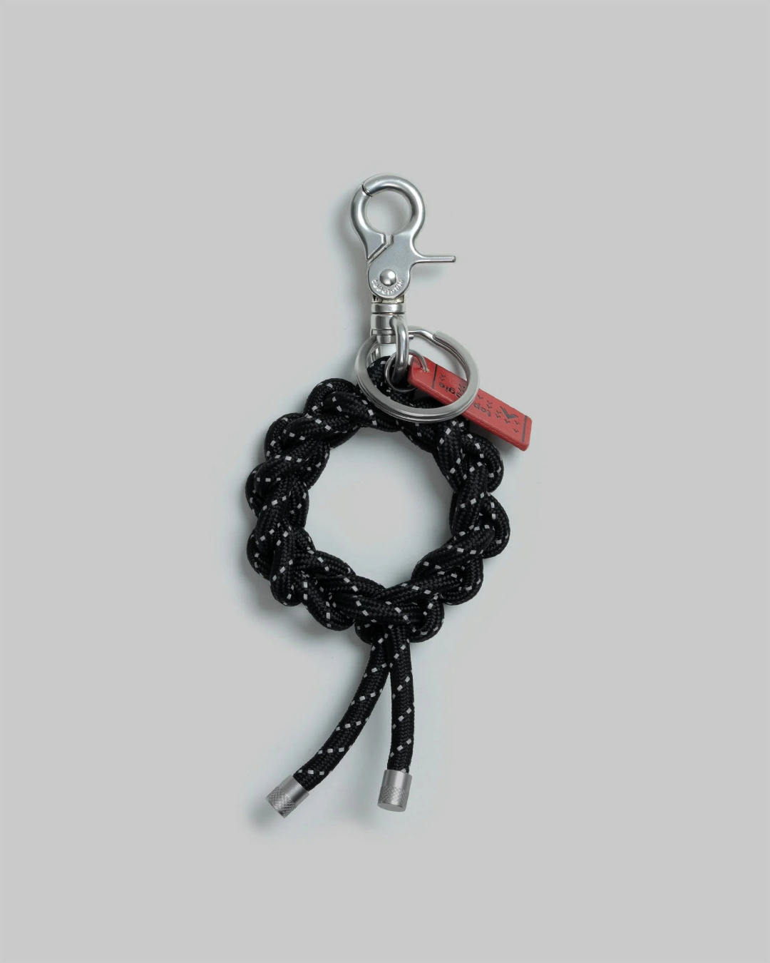 Porte-clés Merci Paris Topologie Krans en corde tressée noire avec mousqueton métallique et étiquette rouge