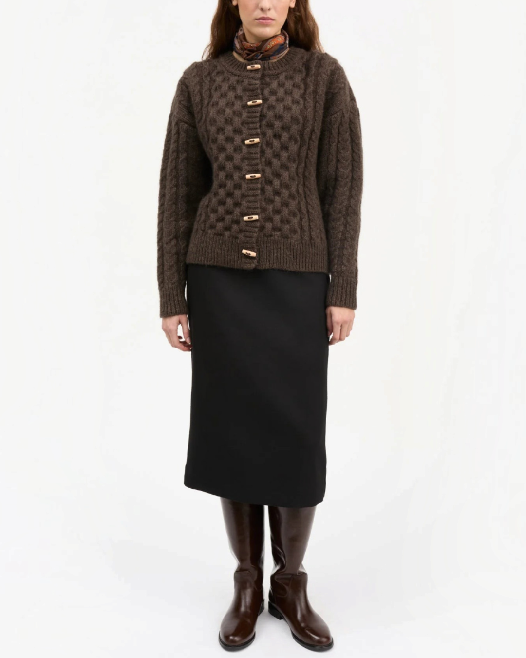 Model wearing the dark brown Lennox cable wool cardigan from Merci Paris with wooden buttons