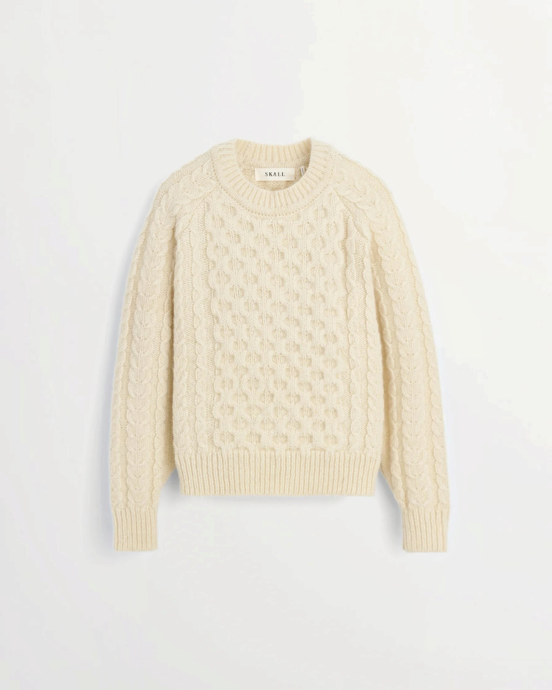 Pull Lennox blanc en laine à maille torsadée de la marque Merci Paris, avec manches raglan et col rond.
