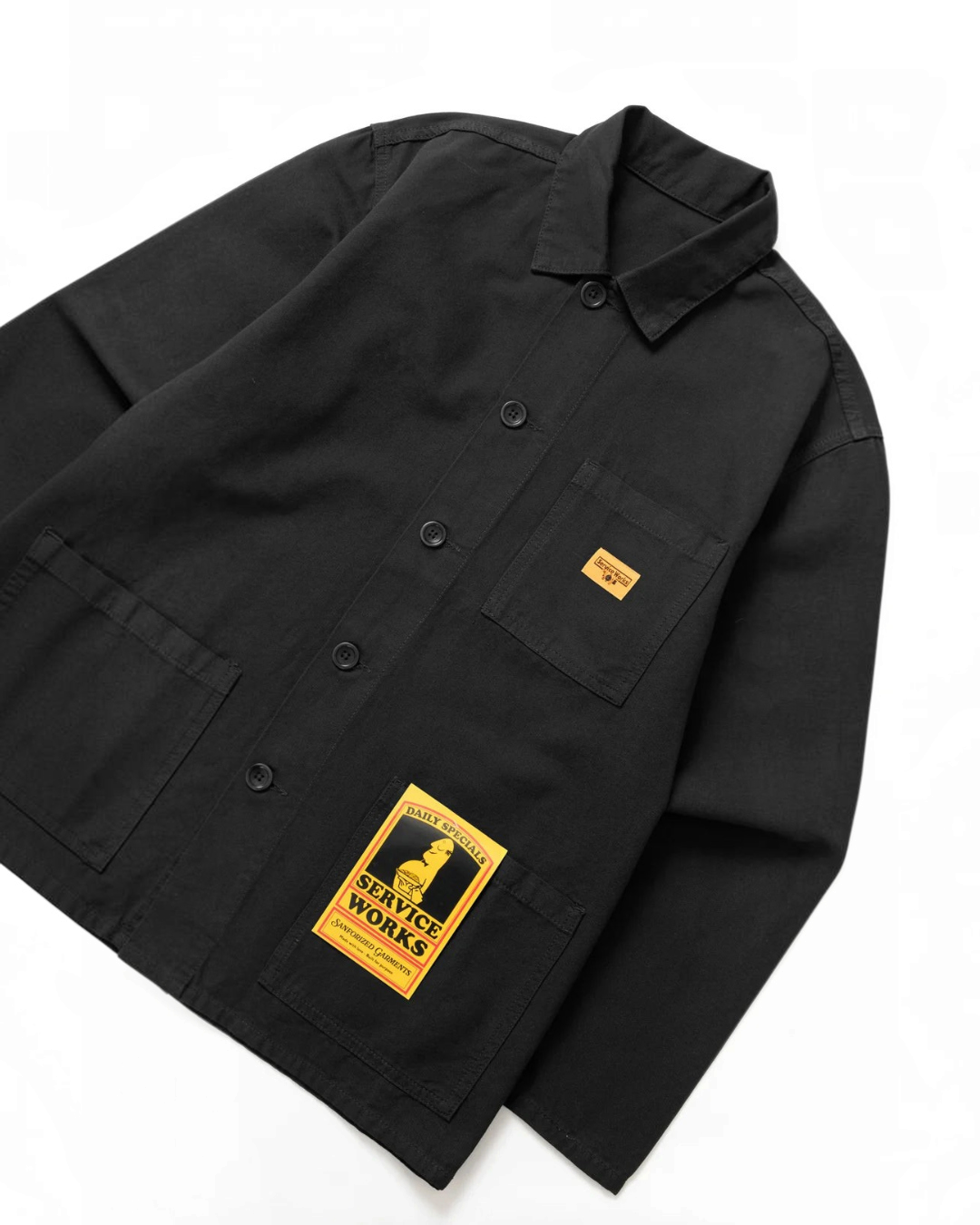 Veste de travail noire Service Works en toile de coton biologique épaisse avec poches et étiquette signature Merci Paris